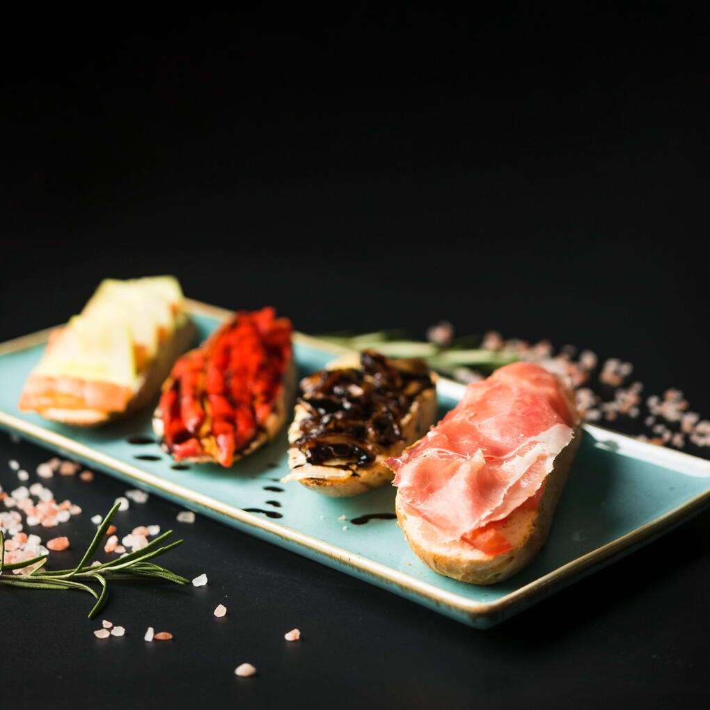 Sampler Board Small bites of Caviar Canapes, King Urchin Loaf, Finger Sandwiches, and Persimmon Leaf Sushi to whet your appetite.