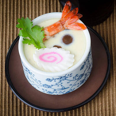 Chawan-Mushi Whisked egg mixed with fish broth, meats, and seasonal vegetables, then steamed until transformed into a savory custard.