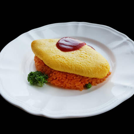 Omurice Delightful fried rice wrapped in a creamy omelette and topped with our house-made ketchup.
